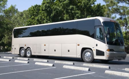 a plain charter bus parked in a parking lot